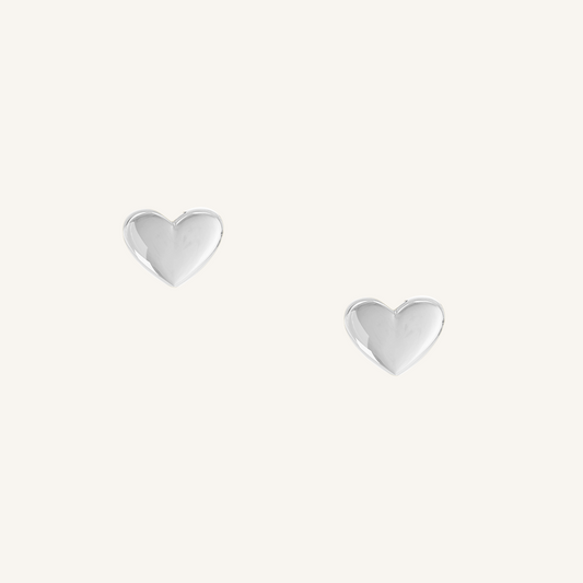 heart shaped silver studs on white background 