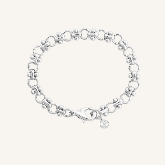 silver chain bracelet inspired by Eiffel tower on plain background