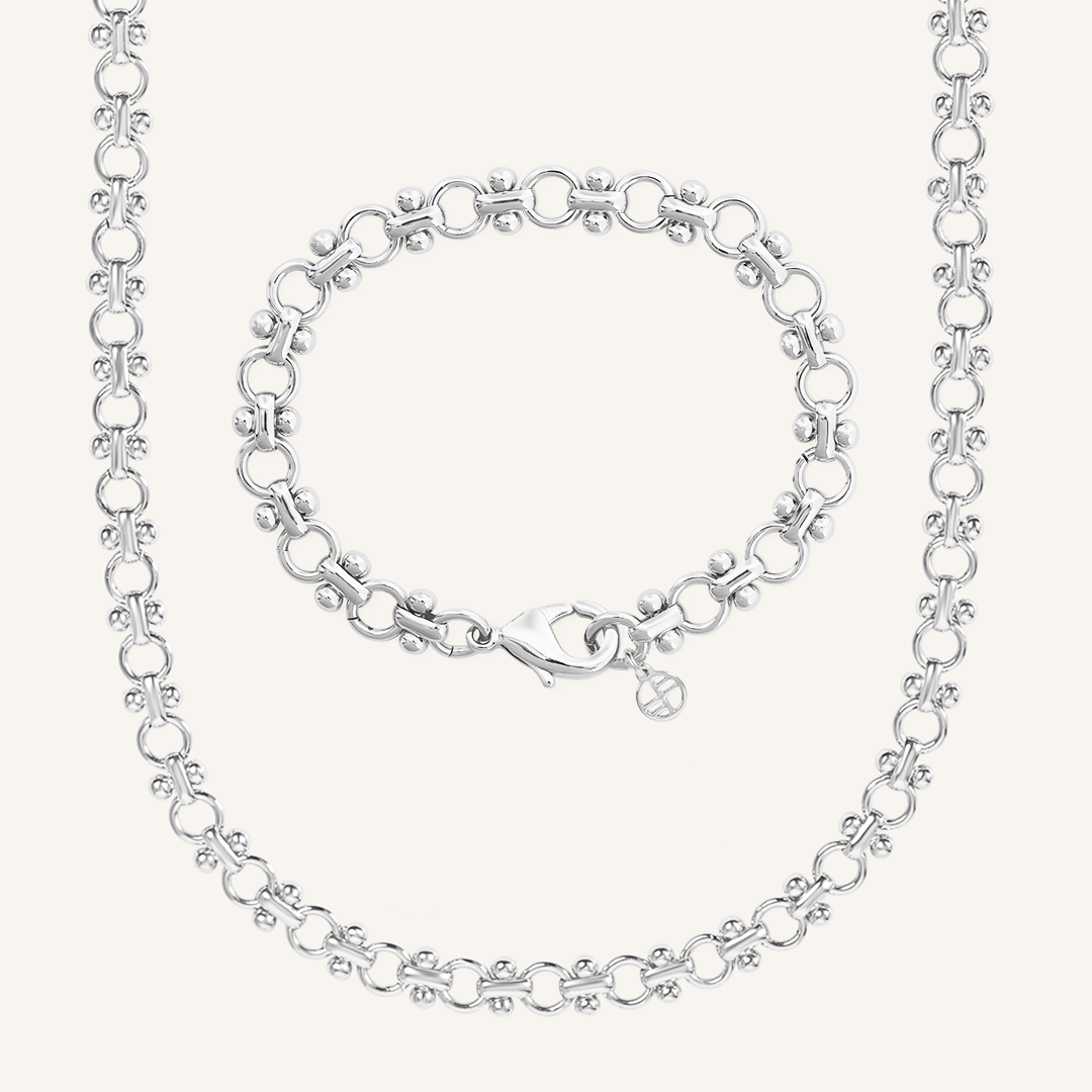 silver chain bracelet and chain necklace set inspired by Eiffel tower on plain white background