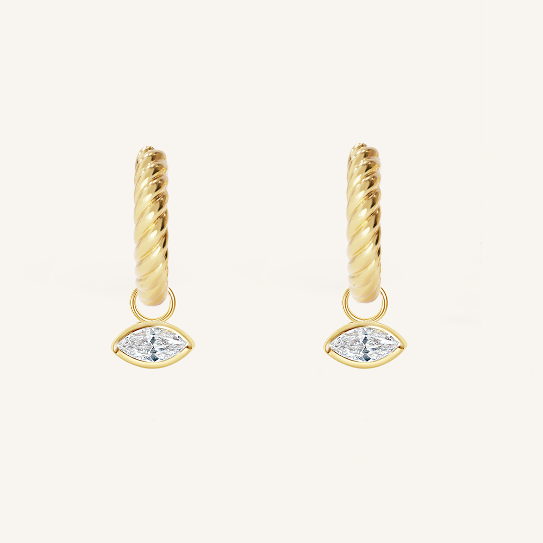 gold hoops inspired by the Louvre's architecture with Marquise cut white cubic zirconias bezel set hoop charms on white background