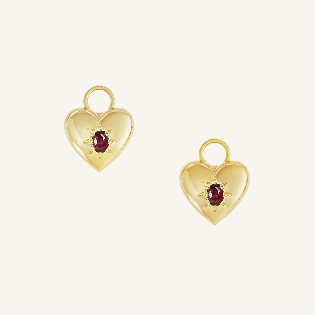 gold hoop charms with heart charms with deep red oval cubic zirconias on white background