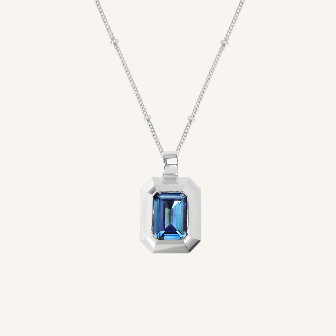 silver charm with Blue emerald cut cubic zirconia bezel set Inspired by the halls of Versailles on bobble chain on white background 