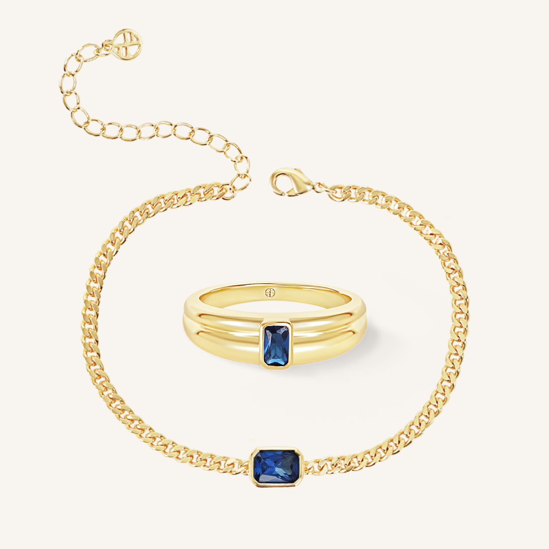 gold chain bracelet with a navy blue cubic zirconia bezel set in a set with gold ring with navy blue cubic zirconia  