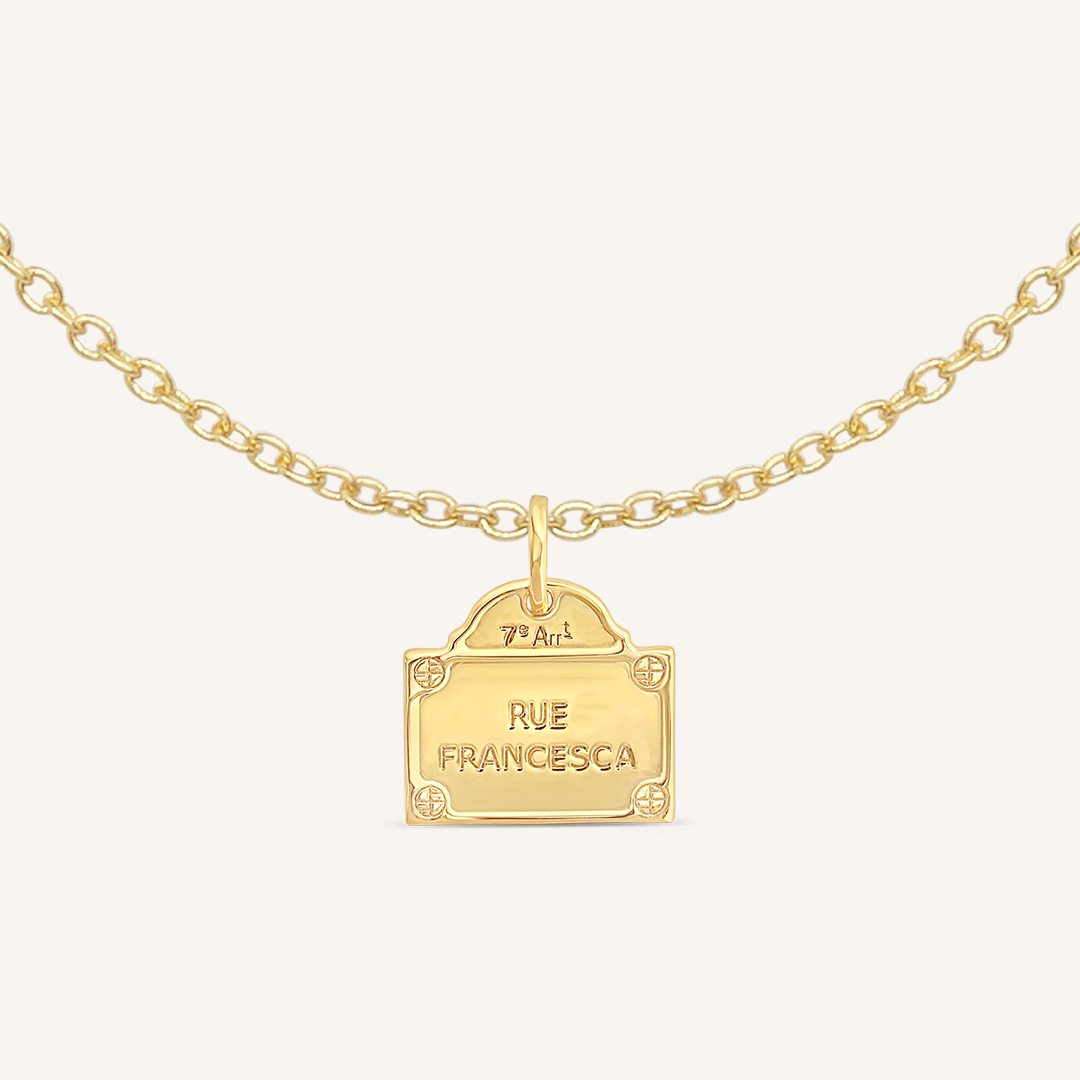 gold charm Inspired by the street signs in Paris on plain chain on white background