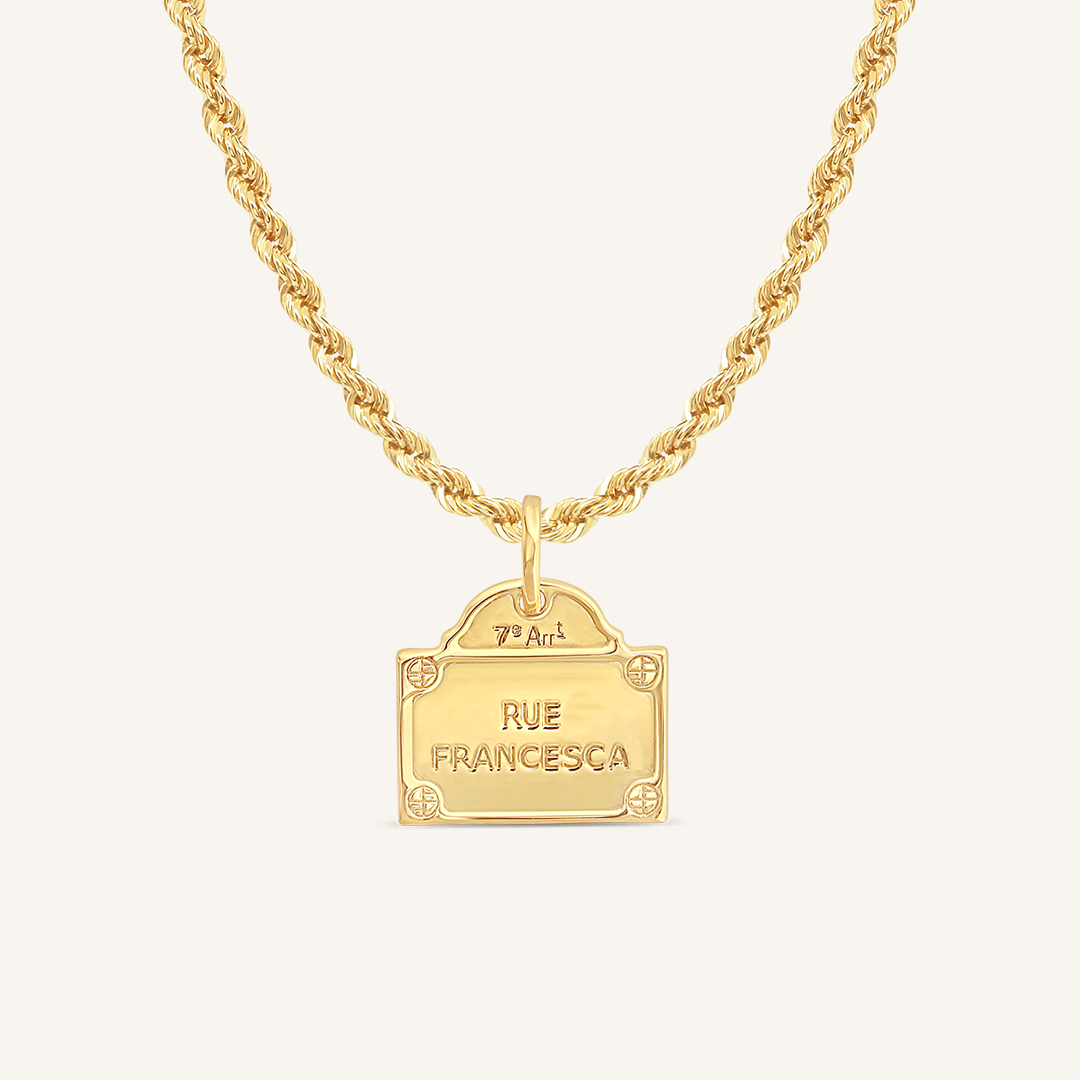 gold charm Inspired by the street signs in Paris on rope chain on white background
