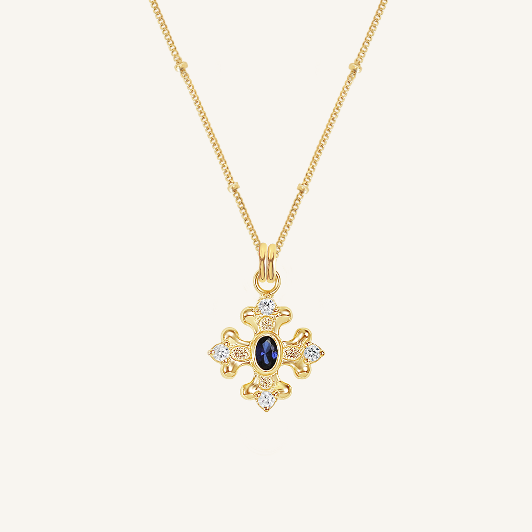 features the intricate fleur-de-lis details found in the iconic Palace of Versailles accompanied by the deep blue stone on bobble chain on white background