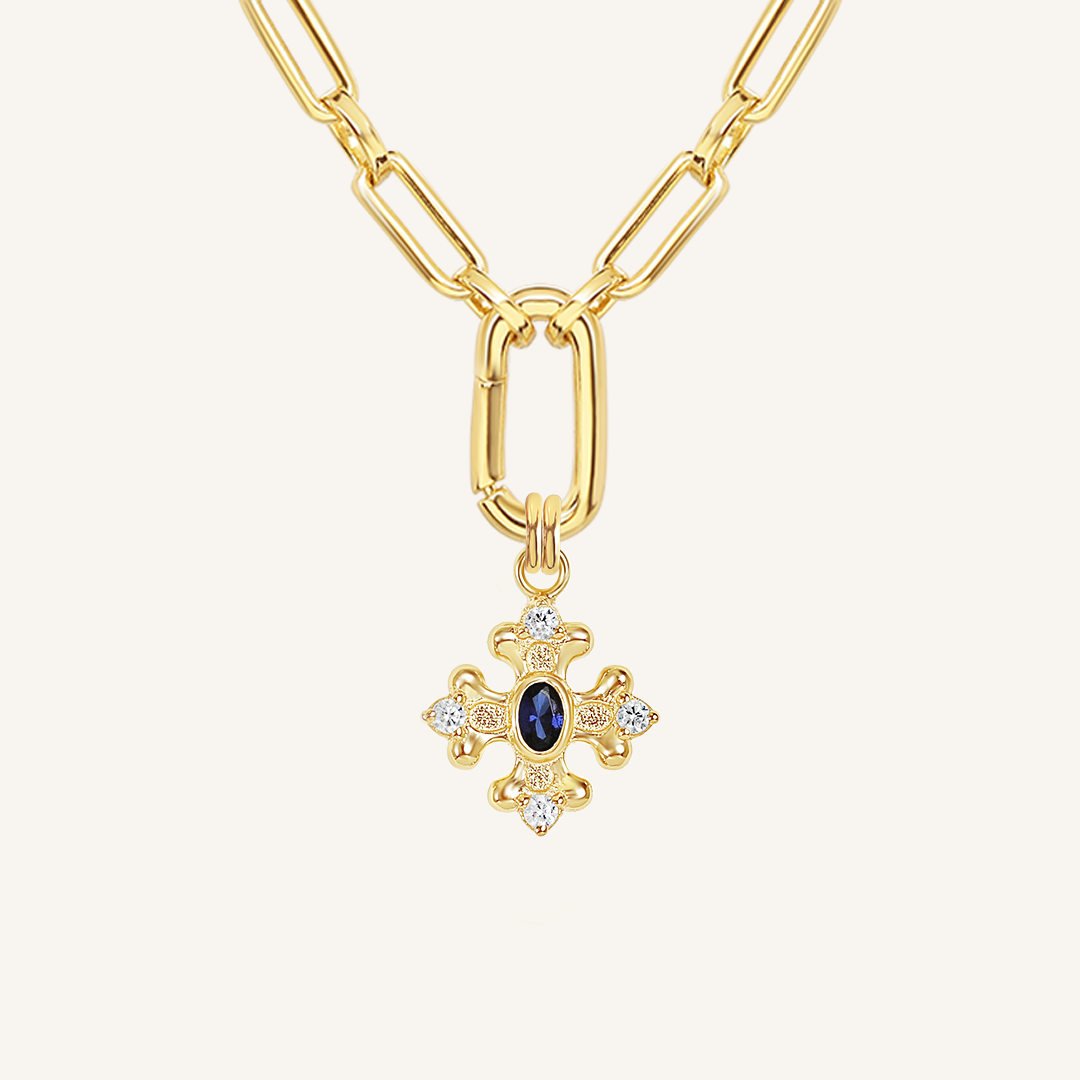 features the intricate fleur-de-lis details found in the iconic Palace of Versailles accompanied by the deep blue stone on link chain on white background